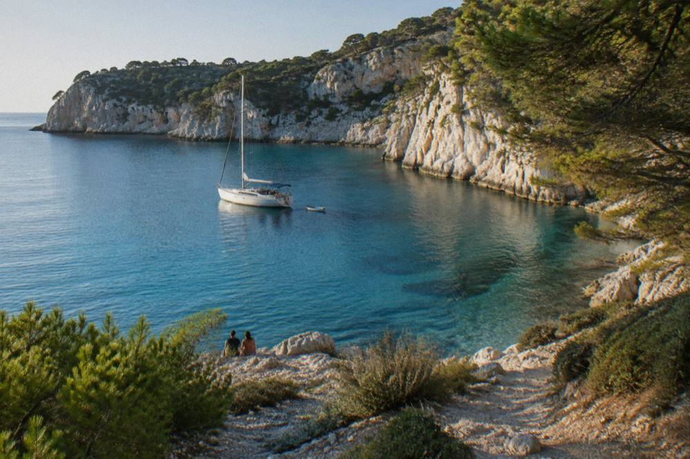 A sheltered turquoise cove with an anchored boat and pale cliffs in Telašćica Nature Park
