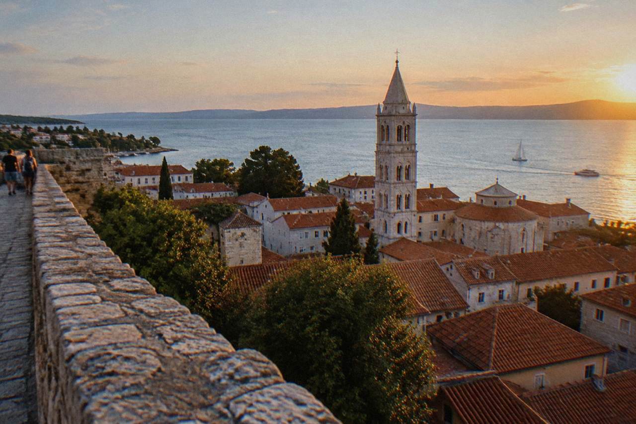 Zadar's old peninsula with stone buildings and a bell tower seen from a high bastion wall