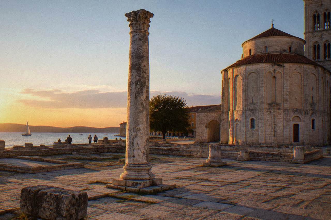 An ancient Roman column among worn paving stones at the Roman Forum in Zadar at golden hour