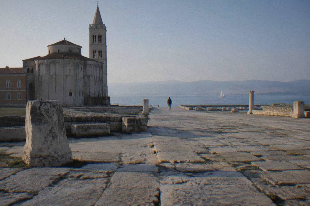 Wide paved area of the Roman Forum in Zadar with large stone blocks on a sunny day