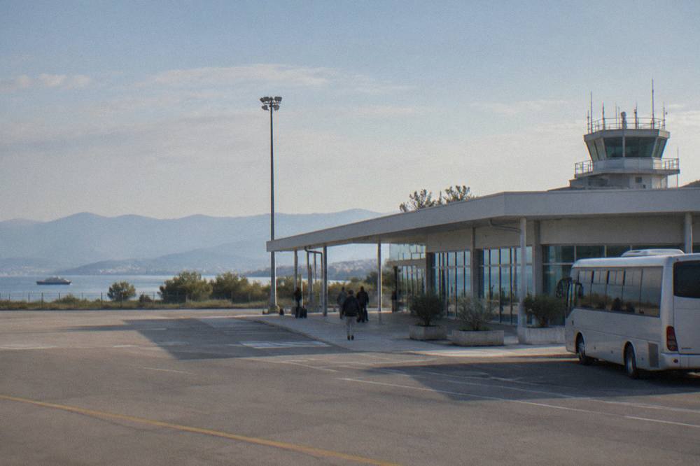 Small low terminal building at Zadar airport on a sunny morning with a quiet forecourt