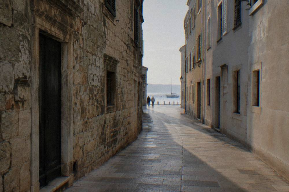 Narrow stone street in Zadar Old Town with a mix of old and rebuilt facades