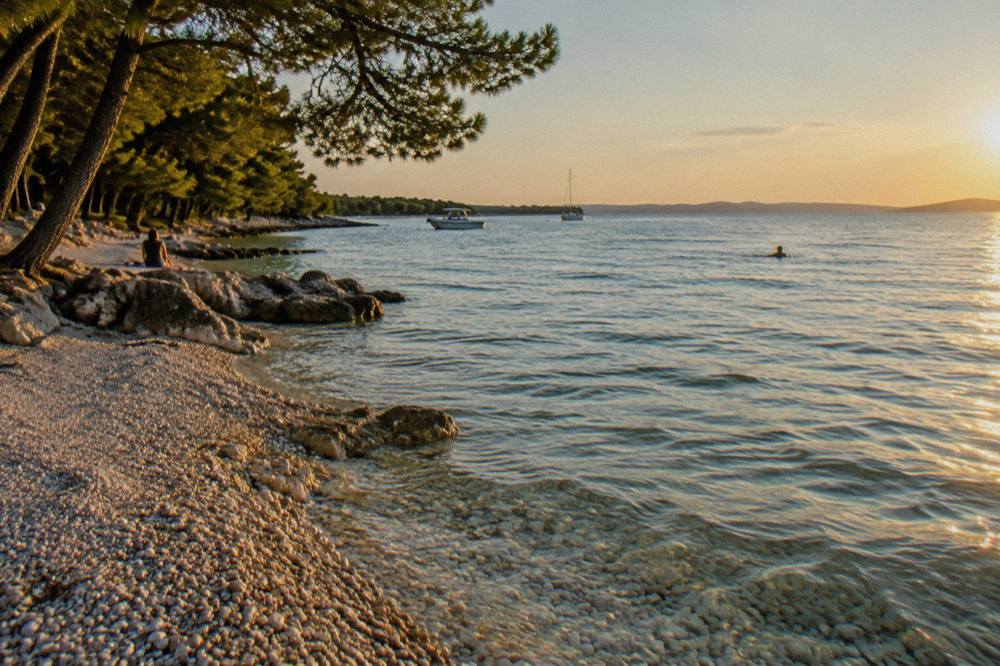 Shallow clear water over pale pebbles on a Borik beach