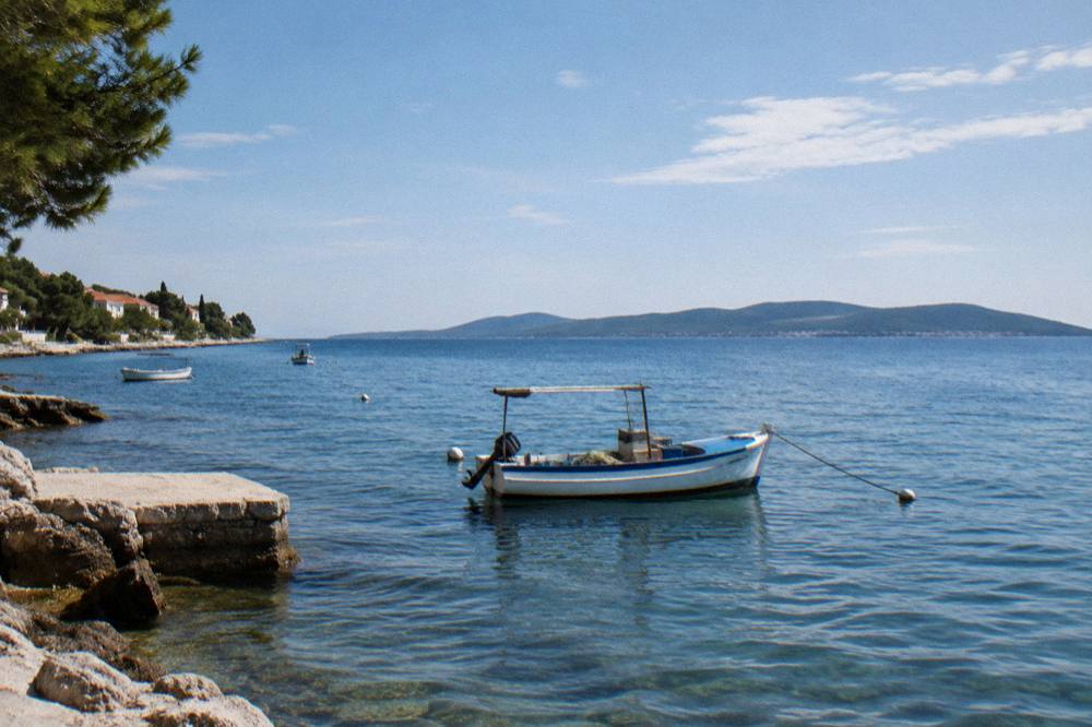 Fishing boat in a quiet Diklo bay with Ugljan on the horizon