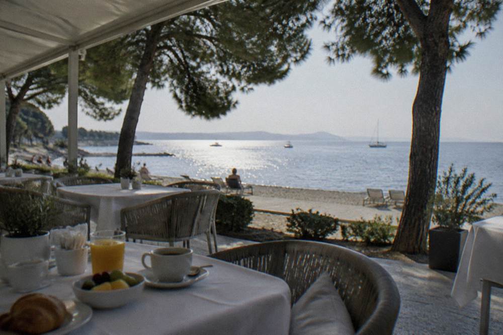 Hotel breakfast terrace overlooking the sea at Kolovare in soft natural light