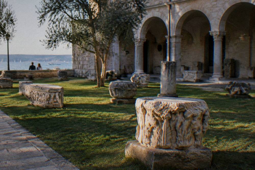 Stone courtyard with carved fragments and arched colonnade in the Old Town