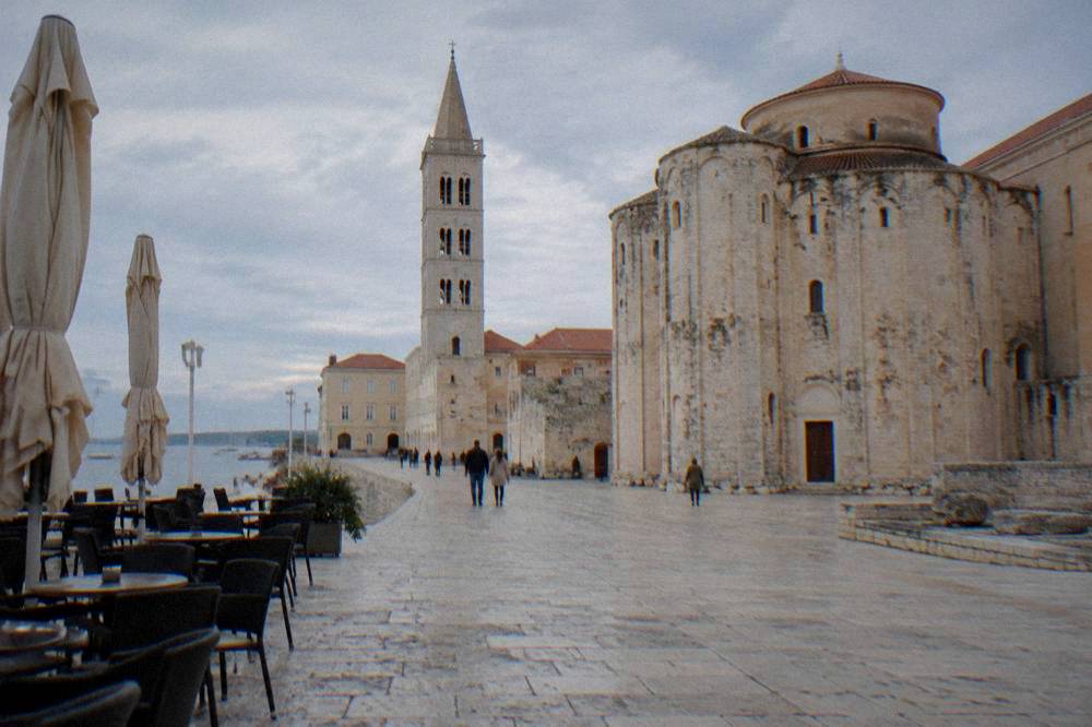 Old Town square with cafe chairs near the cathedral and a tower