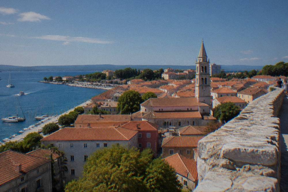 Old Town rooftops and a bell tower seen from a high wall
