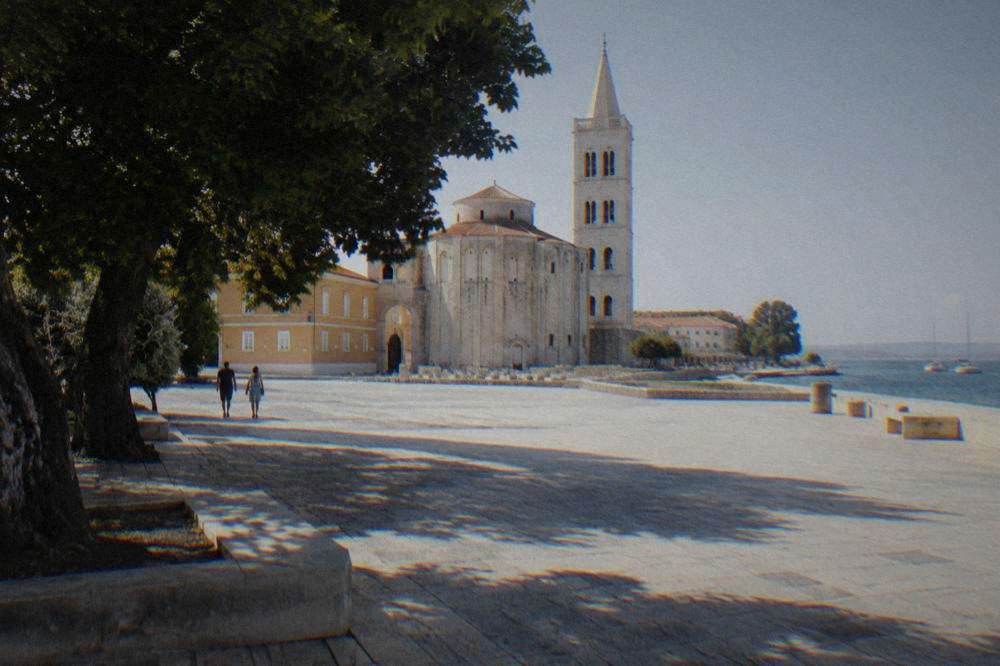 Empty paved square in long morning shadows in soft natural light