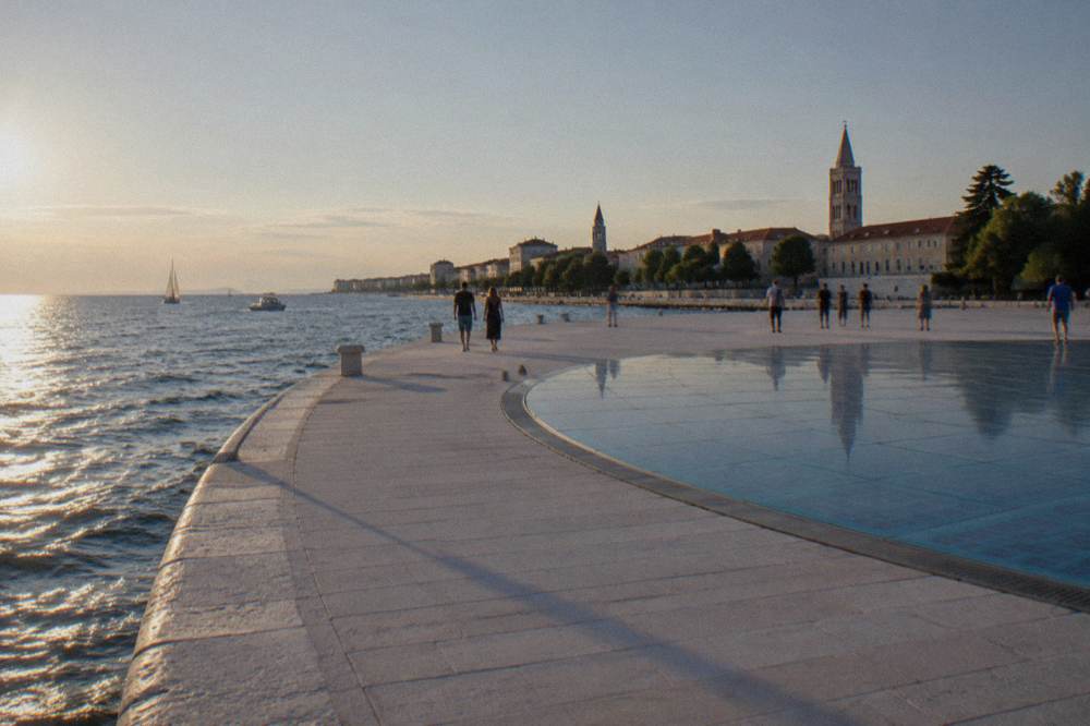 Waterfront promenade curving toward the glass circle on the Zadar peninsula