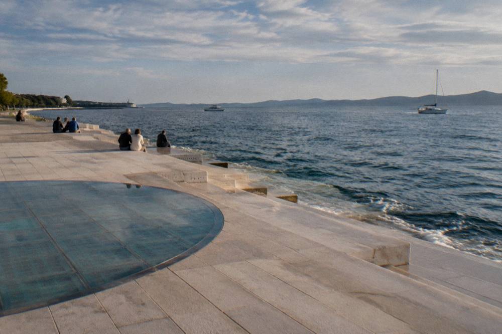Marble steps down to the sea near the glass circle