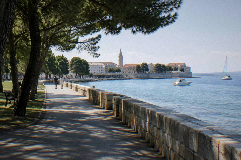 Old Town sea wall and calm blue water beyond the street