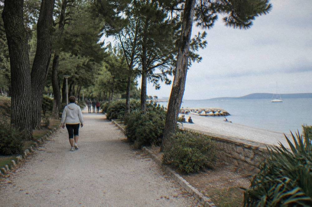 Shaded park path from the Old Town toward Kolovare beach