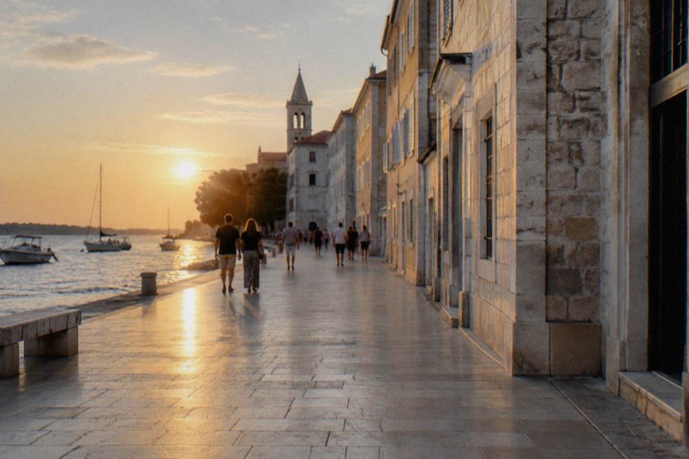 Long polished limestone pedestrian street leaving the square in soft natural light