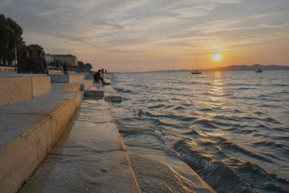 Late afternoon waves lapping the marble steps with distant listeners