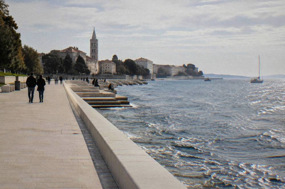 Waterfront promenade leading toward the marble steps at the sea edge