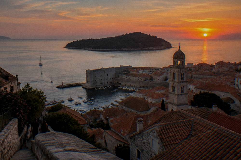 Dubrovnik rooftops from a hillside viewpoint at sunset in summer light