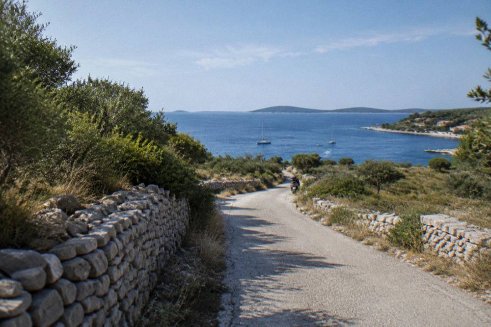 Narrow island road through scrub and dry stone walls on Dugi Otok