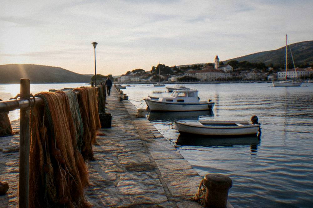 Stone breakwater and drying fishing nets in a small Dugi Otok harbour
