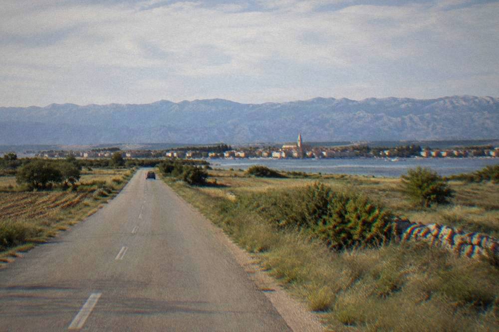 Flat road toward Nin with the Velebit ridge in the distance