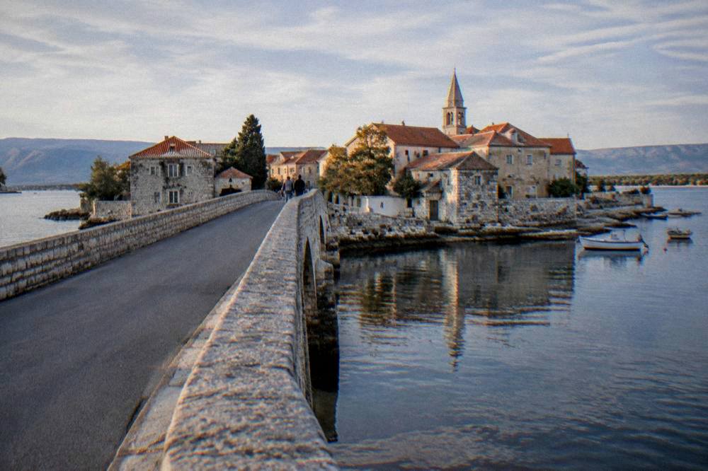 Stone bridge entrance to the island town of Nin at late afternoon