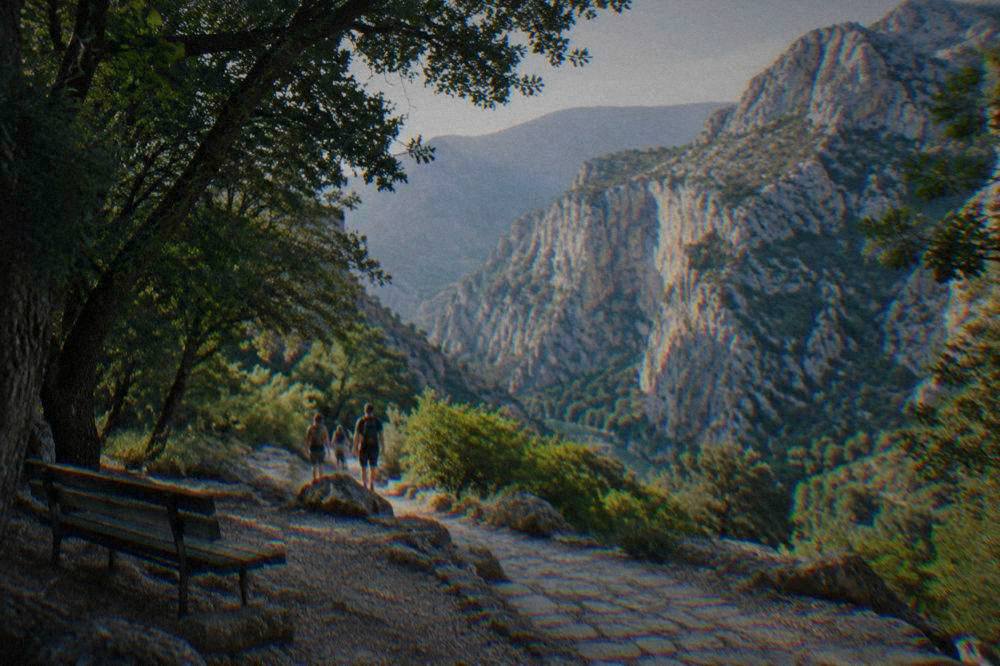 Trailhead footpath in shady trees at the mouth of the canyon