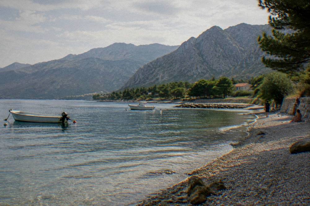 Small seaside beach near Starigrad with mountains rising behind in soft natural light
