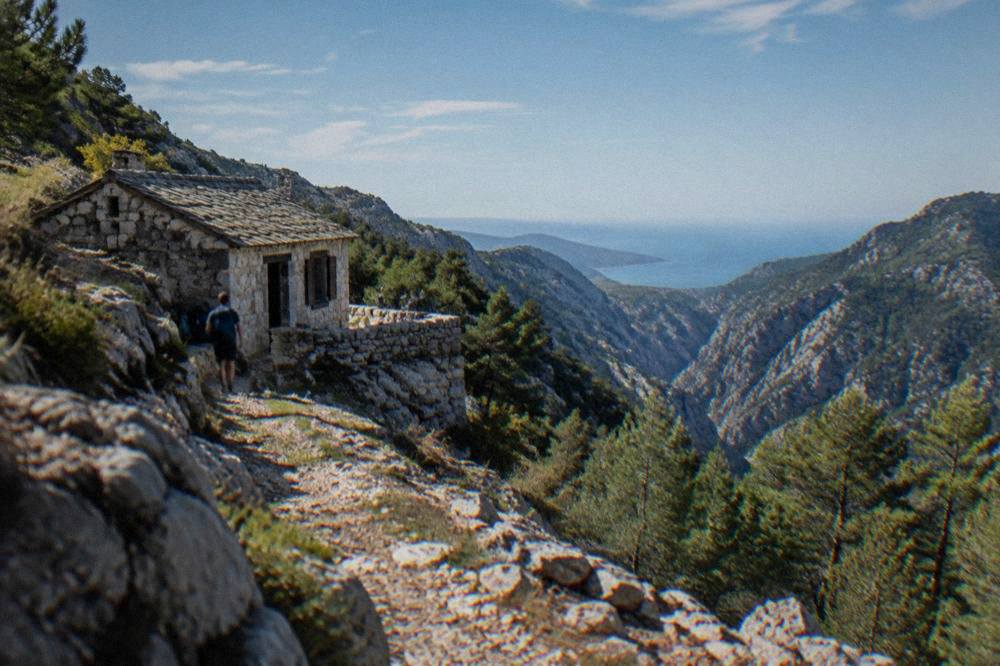 Stone shelter on a ridge trail overlooking a limestone canyon