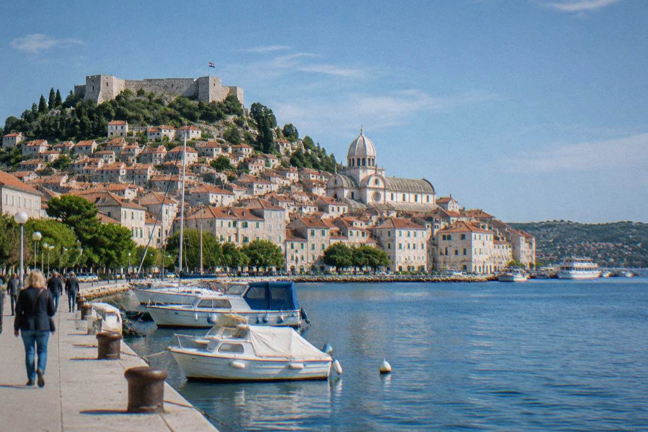 Sibenik old town rising from the waterfront with a pale cathedral dome