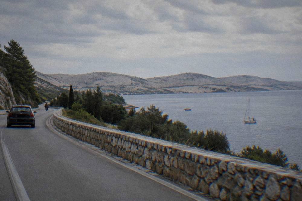 Adriatic road with pale hills and olive groves beside the sea