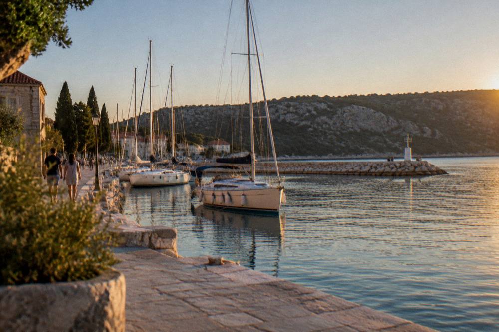 Marina with sailboats and a stone breakwater near Skradin on a clear day
