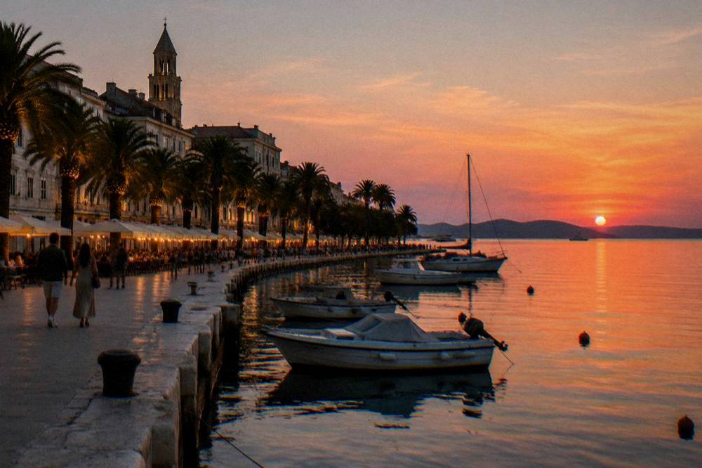 Split Riva at dusk with lit palms and moored boats