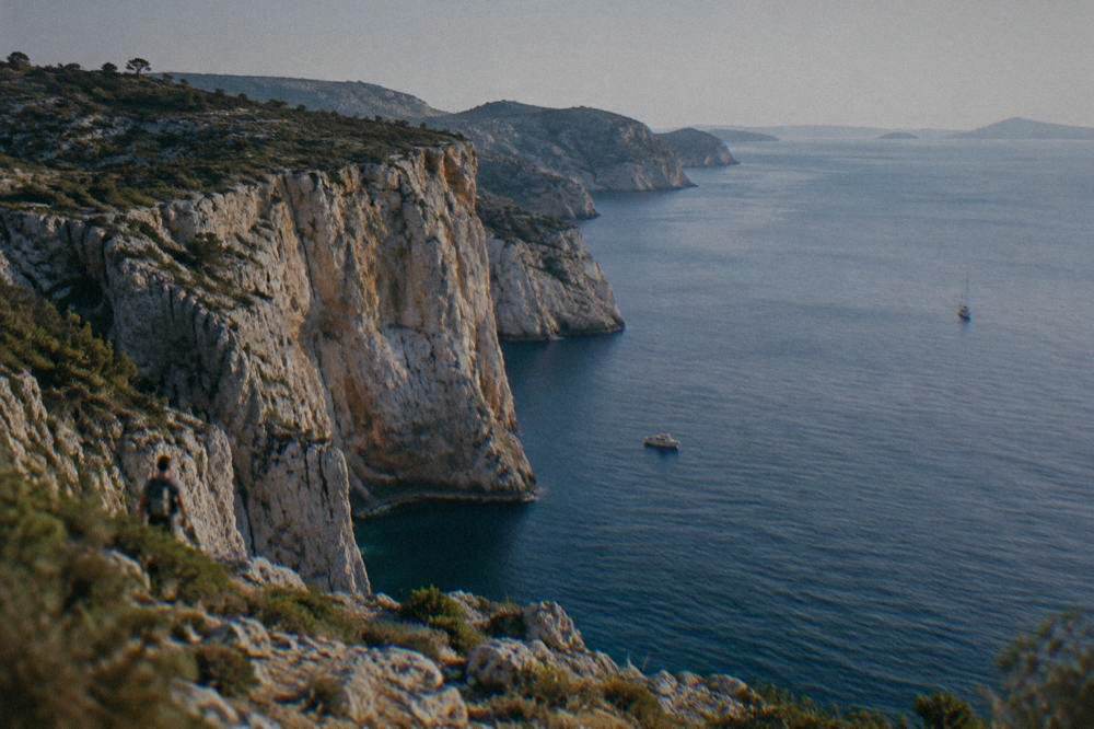 Tall sheer limestone sea cliffs dropping into deep blue water