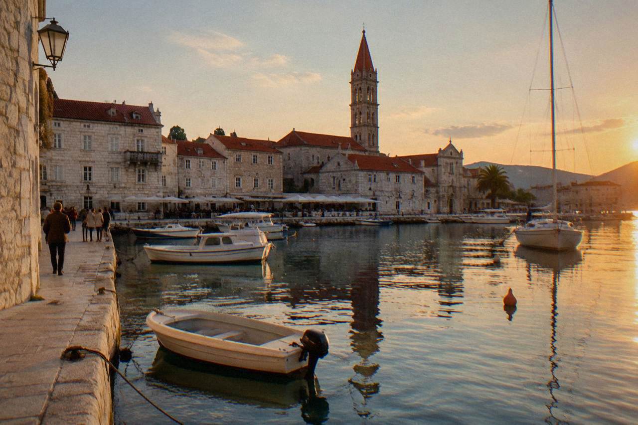 Trogir island old town waterfront with moored boats and bell tower