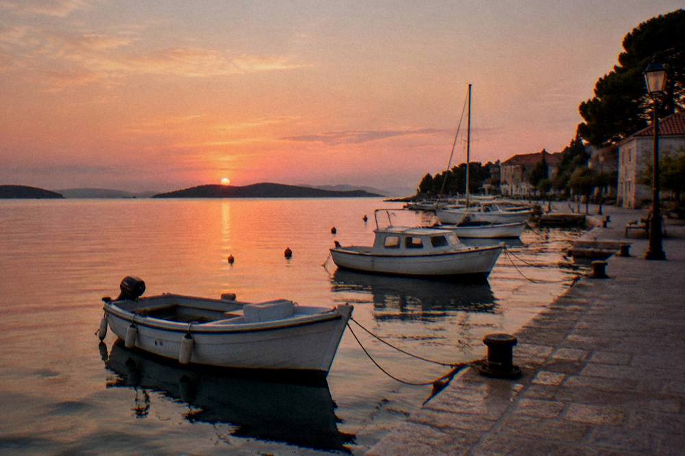 Evening on Preko quay with a soft pink sky and gently rocking boats