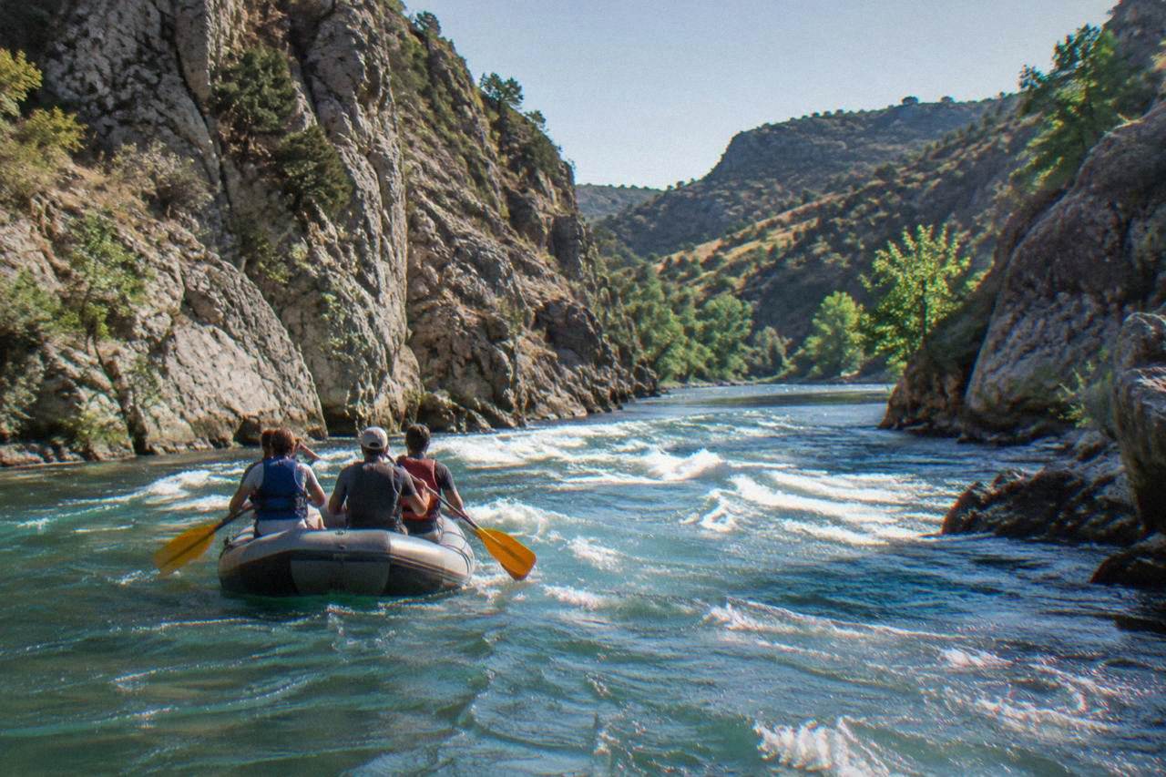 Raft with paddlers seen from behind on the Zrmanja river canyon