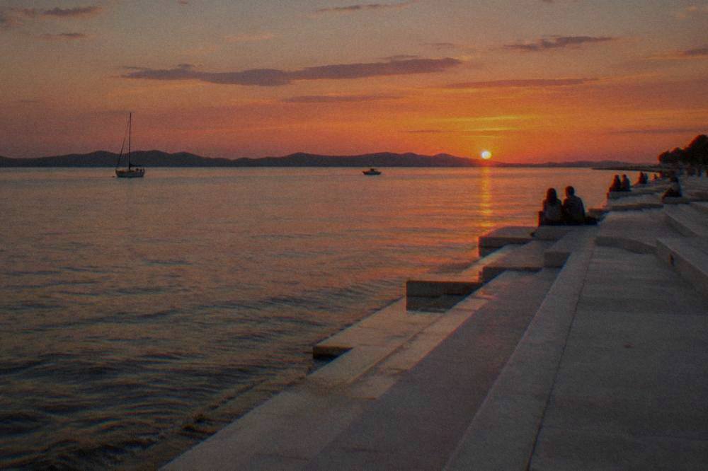 The white steps of the Sea Organ along Zadar's waterfront at sunset.