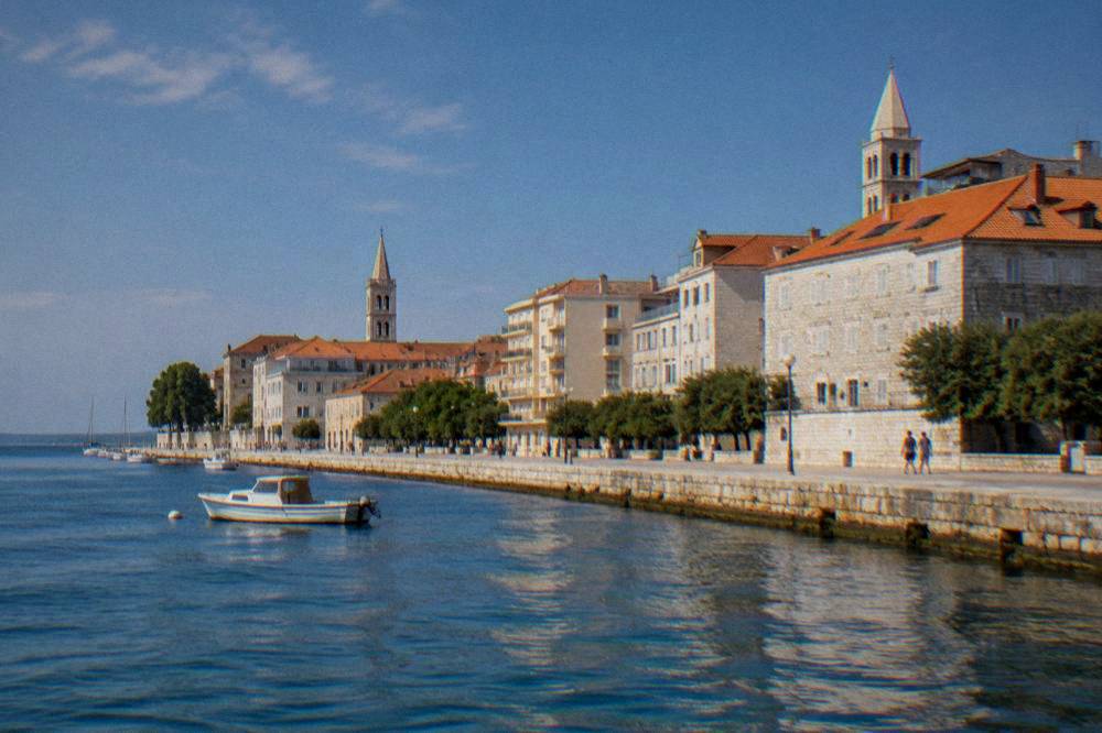 Rebuilt stone houses and terracotta roofs on the Zadar peninsula seen from the sea wall.