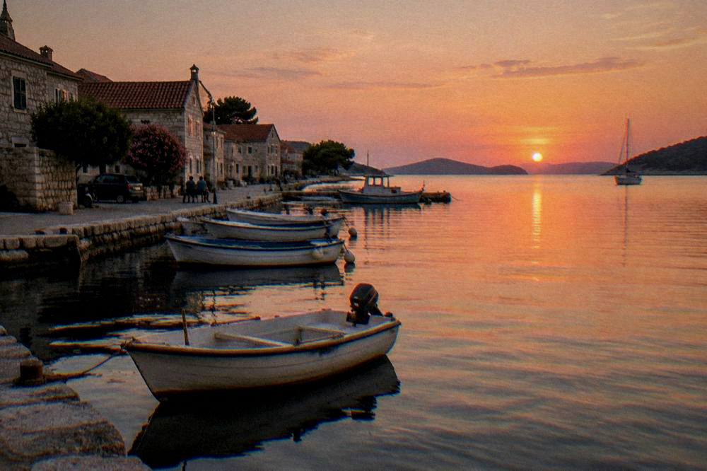 Boats and low stone houses around the small harbour at Sali on Dugi Otok.