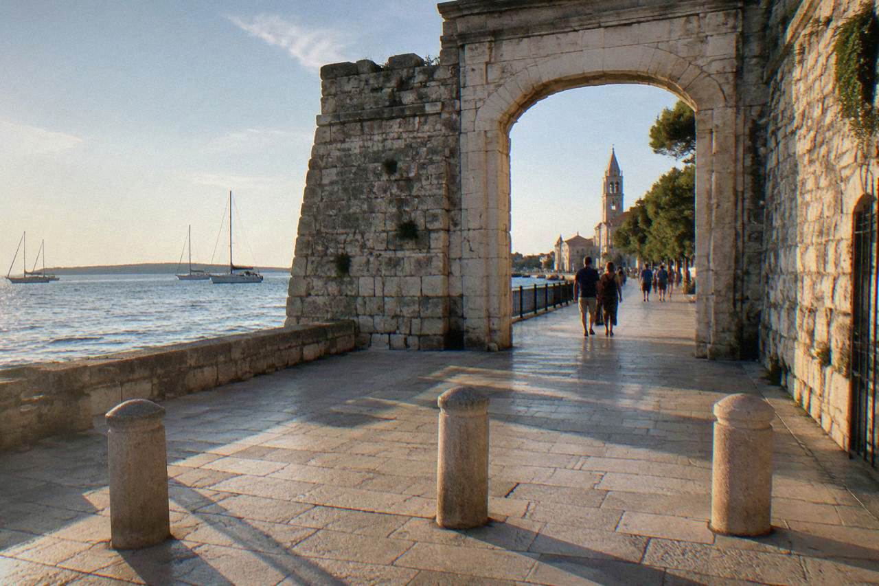 A pedestrian entry into Zadar old town with bollards and limestone paving.