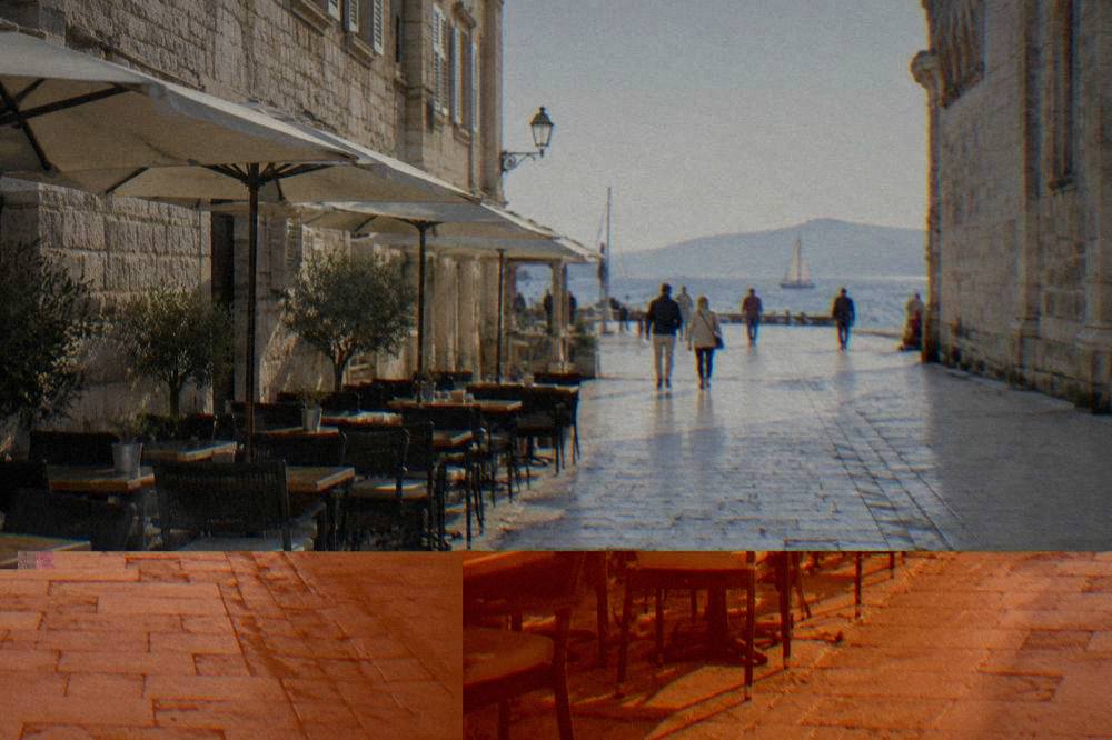 The car-free limestone street of Kalelarga in Zadar with a few distant walkers.