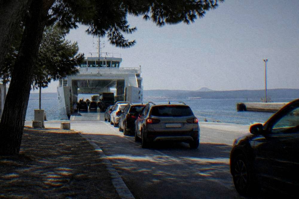 Cars queued on the ramp beside a docked car ferry at Gaženica port in Zadar.