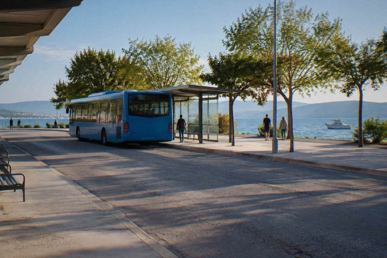 A city bus at a stop shelter at Zadar bus station on a bright morning.