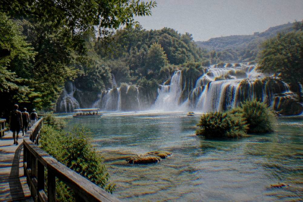 Waterfalls and green pools lined by trees at Skradinski Buk in Krka National Park.