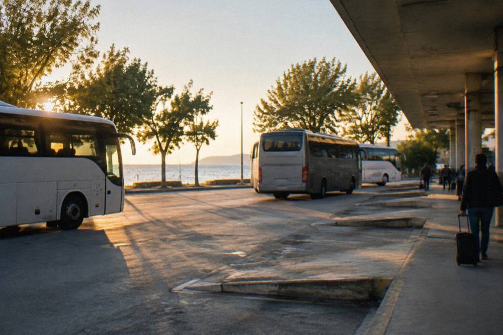 Coaches at bus bays at Zadar bus station in morning sun.