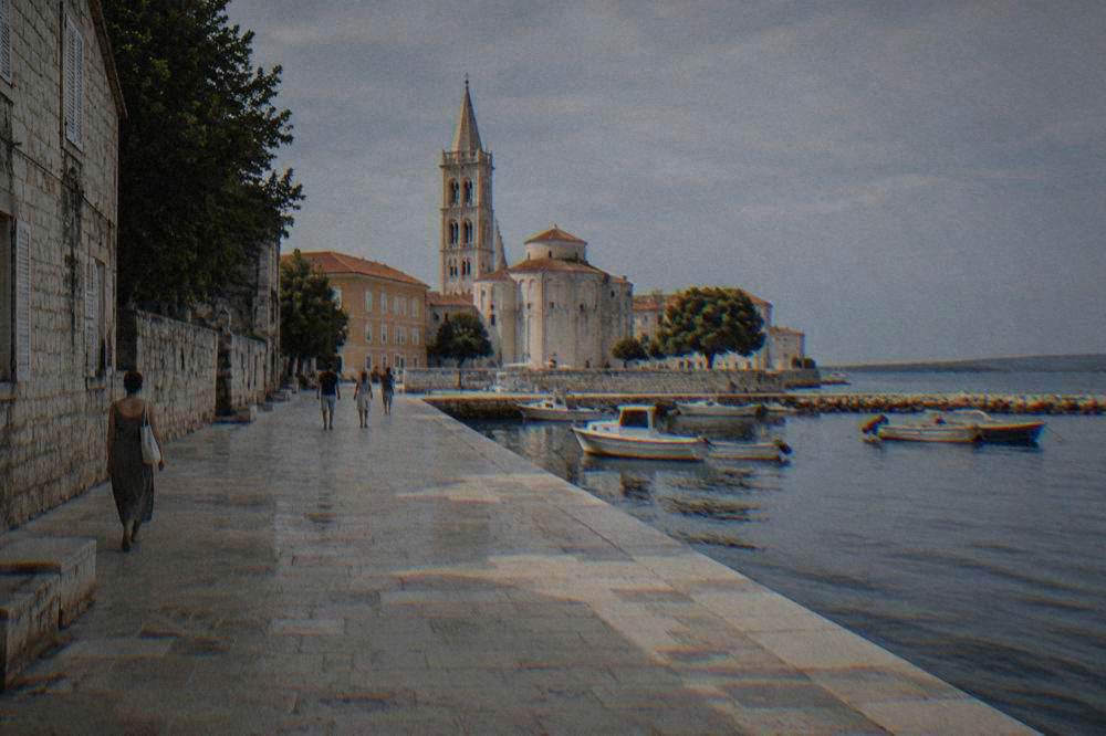 Zadar old town in clear summer light with long shadows on limestone paving.