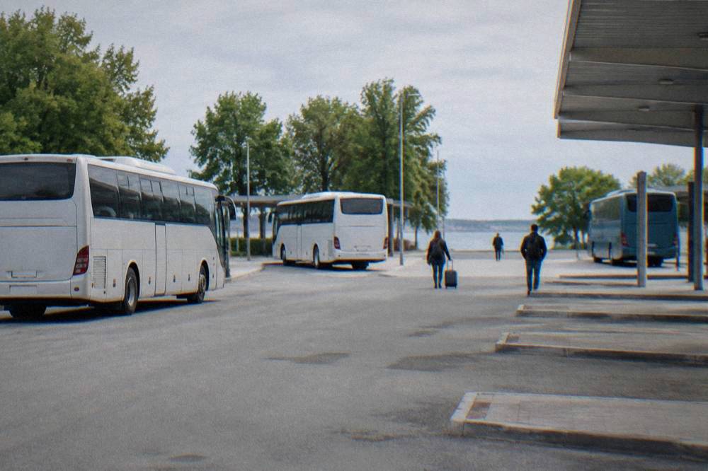 Coaches at bus bays at Zadar bus station in sunlight.