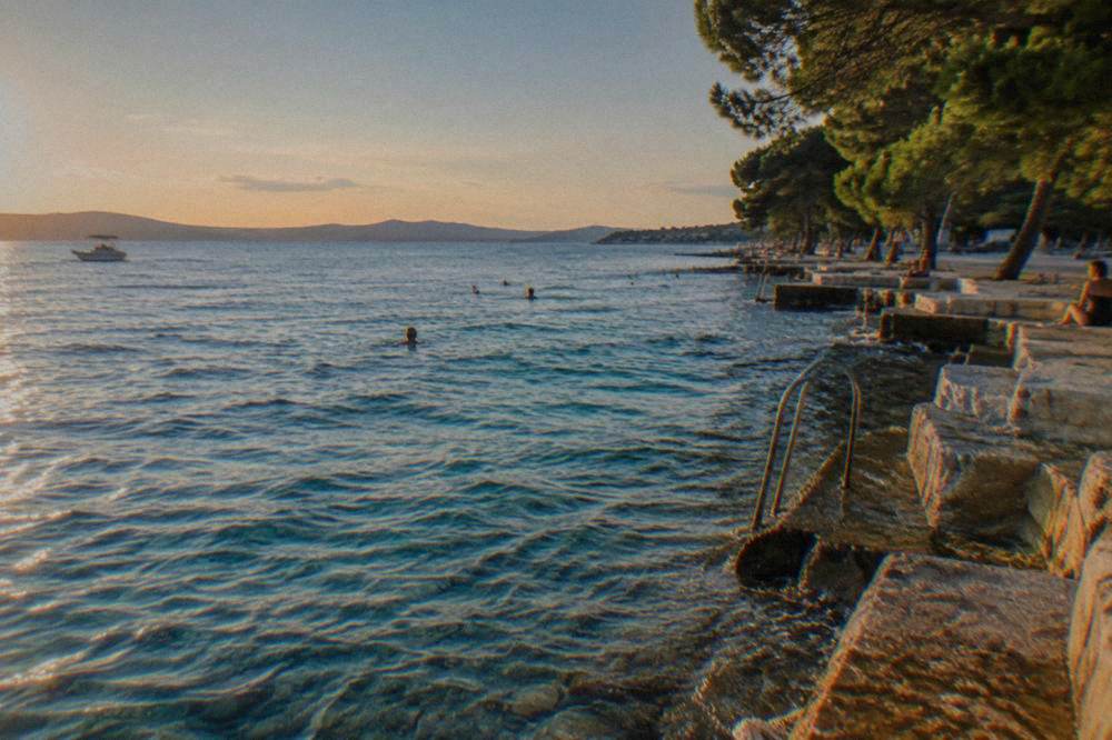 Clear turquoise water and stone steps at Kolovare Beach in Zadar.