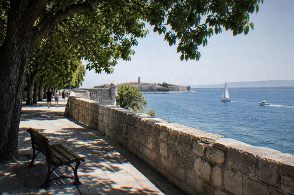A stone promenade along the old city walls above the Adriatic in Zadar.