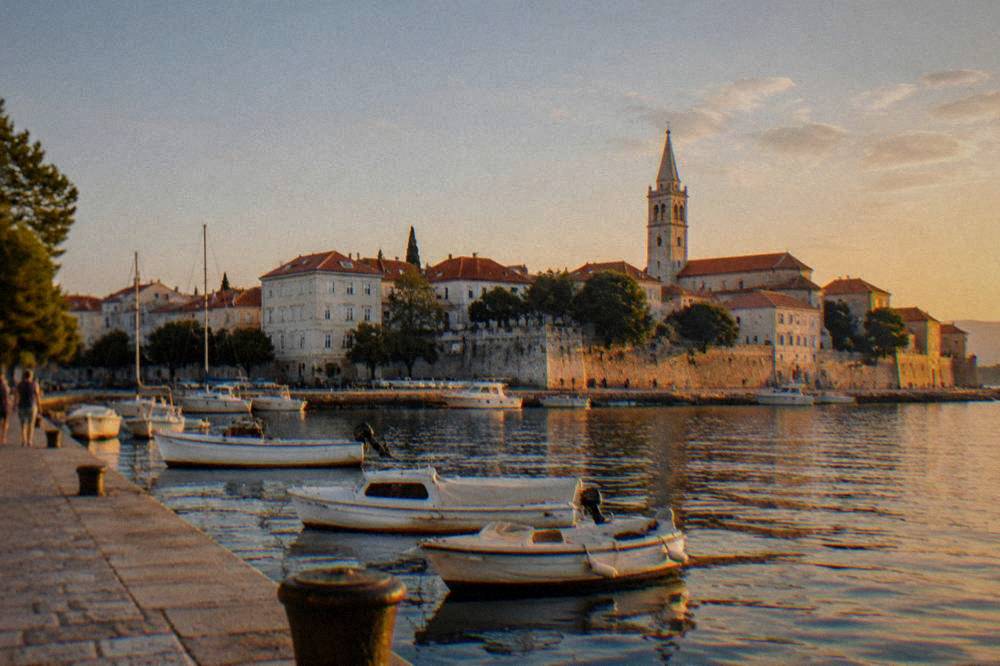 First view of Zadar old town with terracotta roofs and bell tower from the harbour quay.